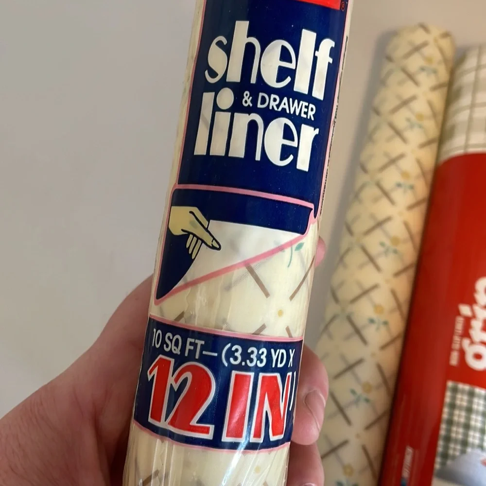 Five rolls of Rubbermaid shelf liner, some adhesive some not 3 full new rolls